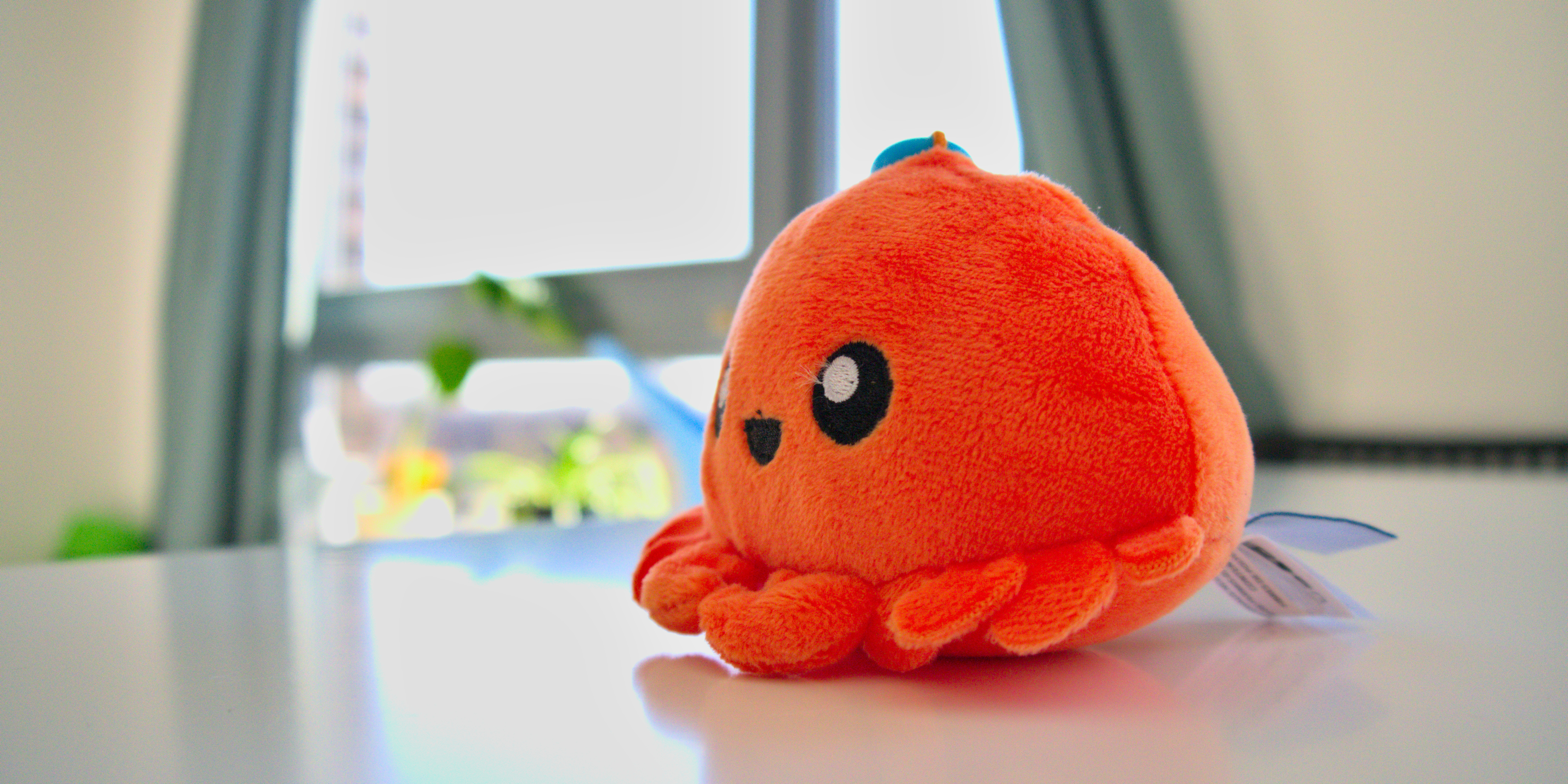 A picture of Ferris, the Rust mascot. An orange crab plushie.